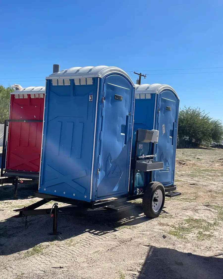 Portable toilet mounted on a tow trailer